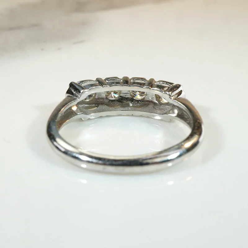 Four Sparkling Diamonds in Curvy White Gold Band